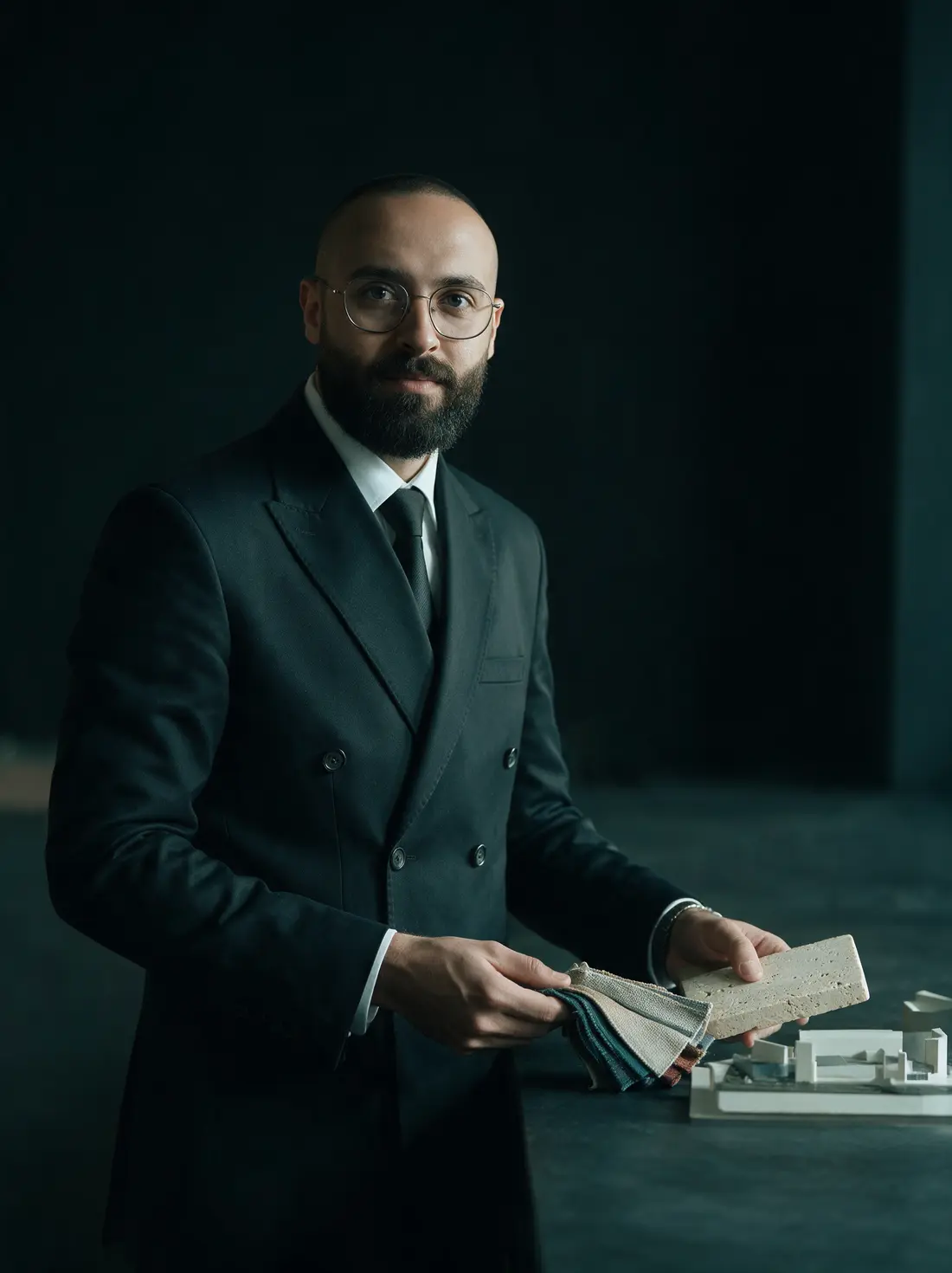 Cinematic portrait of Moustafa Kandeel holding material samples
